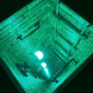 May include: A green brick tunnel with a rope ladder and light bulbs. The tunnel is lit with a green light.