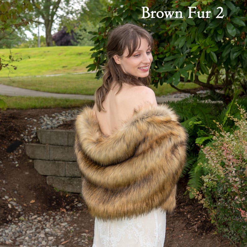 May include: A brown faux fur shawl with a long, flowing design. The shawl is made of soft, plush fabric and has a luxurious feel.