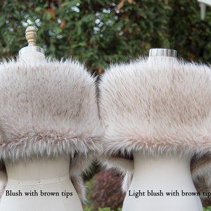 May include: Two faux fur stoles, one blush with brown tips and one light blush with brown tips.