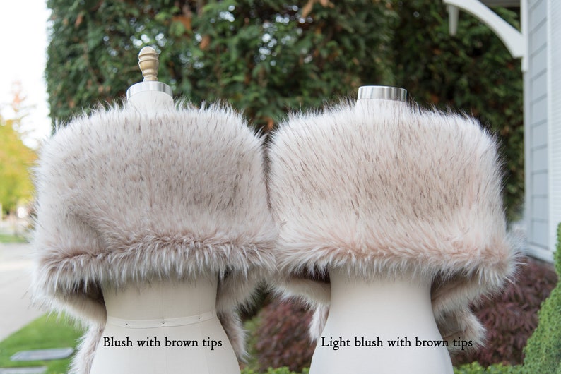 May include: Two faux fur stoles, one blush with brown tips and one light blush with brown tips.