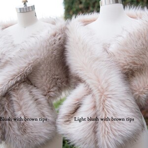 May include: Two faux fur wraps, one in blush with brown tips and one in light blush with brown tips.