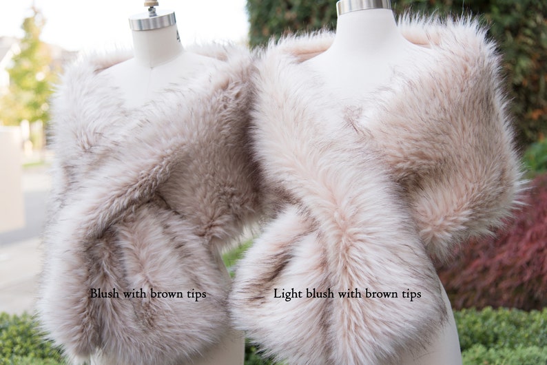 May include: Two faux fur wraps, one in blush with brown tips and one in light blush with brown tips.
