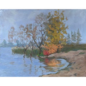 May include: A painting depicting a lake scene with trees in the foreground. The trees are a mixture of yellow, orange, and red. The lake is a light blue colour and the sky is a light grey colour.