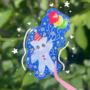 Pegatina de payaso gato volador – Lindo gatito con globos al viento – Pegatina brillante con estética circense – Calcomanía caprichosa de gato para portátil