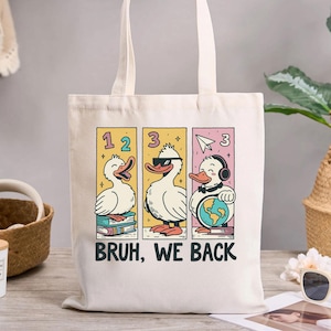 面白いアヒルのBruh We Backトートバッグ、学生や教師への新学期ギフト、クールな漫画のアヒルのデザイン、新学期初日のバッグ