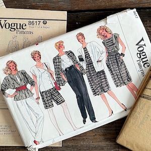 May include: A collection of Vogue 8617 sewing pattern envelopes and instruction sheets. The main envelope features illustrations of various outfits including a jacket, top, and pants. Text includes Vogue Patterns 8617 and 2 inches hem allowed.