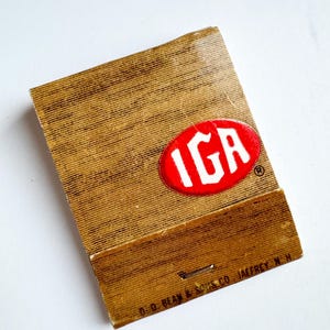 May include: Vintage matchbook with a brown textured cover and the red and white IGA logo. The bottom of the matchbook has the text "D. D. BEAN & SONS CO. JAFFREY N.H."