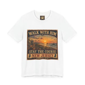 May include: White t-shirt with a graphic depicting a beach sunset, including the text "WALK WITH HIM, STAY THE COURSE, NEW JERSEY, HEBREWS 10:23". The design is reminiscent of a vintage travel poster.