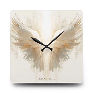 May include: Square wall clock with a watercolour design of angel wings in beige and gold. The clock hands are black. The text "ISAIAH 41:10" is printed at the bottom of the clock face.
