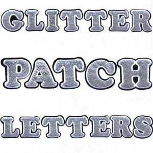 May include: Silver glitter patch letters spelling out "GLITTER PATCH LETTERS" on a white background. The letters have a silver glitter texture with a black border. Perfect for customising clothing or accessories. Ideal for crafting and personalisation projects.