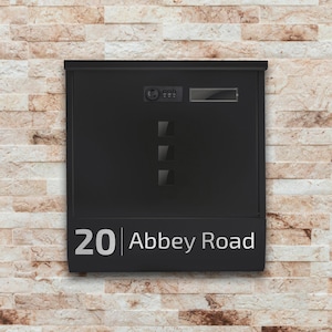 May include: Black mailbox with a silver number 20 and the text "Abbey Road" on the front. The mailbox has a built-in keypad and a small window.
