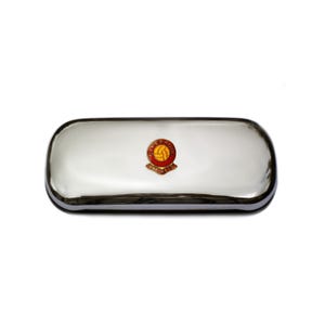 May include: A silver metal eyeglass case with a red and yellow Liverpool FC crest.