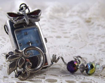 Fancy silver and blue mini table clock from repurposed blue watch face and striking red butterfly charm and beads for bling and romance.