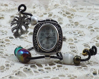 Miniature silver Geneva Elite clock to fit any nook or please nature lover, featuring silver stylized leaf and colorful beads for bling.