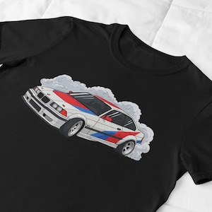 May include: A black t-shirt with a white, red, and blue cartoon illustration of a BMW E30 drifting with smoke coming from the tires.