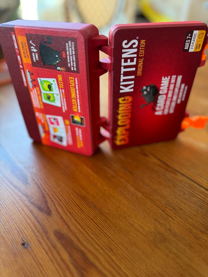 Custom 3D-printed storage box for Exploding Kittens. Holds cards securely with a built-in divider, doubles as a deck and discard holder. UV-printed artwork ensures crisp, vibrant designs. Perfect for organising and upgrading your game night setup.