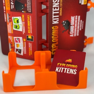 Custom 3D-printed storage box for Exploding Kittens. Holds cards securely with a built-in divider, doubles as a deck and discard holder. UV-printed artwork ensures crisp, vibrant designs. Perfect for organising and upgrading your game night setup.