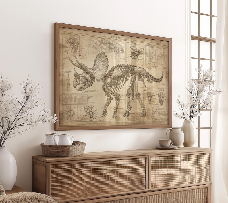 May include: A vintage-style illustration of a Triceratops skeleton with detailed anatomical markings. The image is printed on a beige paper and framed in a brown wood frame.