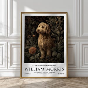 May include: A framed vintage print depicting a golden dog in a garden setting, surrounded by dark green foliage and flowers. The print includes text at the bottom: "COTTON PRINTS EXHIBITION WILLIAM MORRIS". The frame is gold.