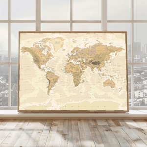 May include: A framed world map in shades of tan and brown, with a vintage aesthetic. The map is detailed, showing continents, countries, and geographical features. The frame is a light brown wood. The map is displayed in front of a window.