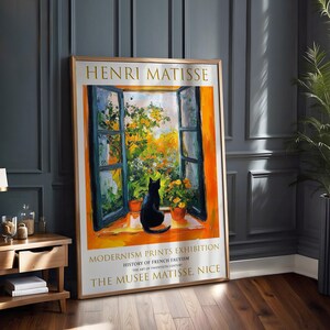 May include: A poster advertising a Henri Matisse exhibition at the Musee Matisse in Nice, France. The poster features a painting of a window with a black cat sitting on the windowsill. The text on the poster reads "Henri Matisse, Modernism Prints Exhibition, History of French Fauvism, The Art of Twentieth Century, The Musee Matisse, Nice."