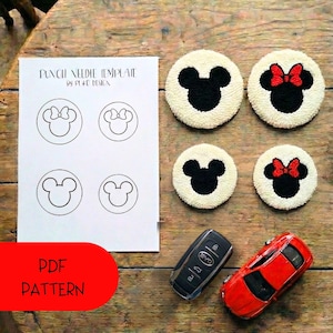 May include: A collection of handmade punch needle coasters featuring Mickey and Minnie Mouse designs. The coasters are white with black and red accents. A PDF pattern template and a red toy car and car key are also in the image.