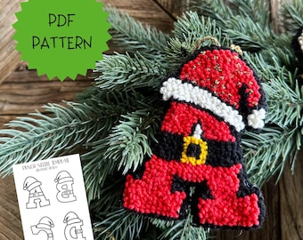 May include: A punch needle pattern PDF featuring a letter A shaped like a Santa Claus suit with a red hat, white trim, black belt, and yellow buckle. The digital template includes outlines for letters A, B, C, and D, each wearing a Santa hat.