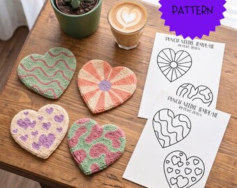 May include: Four heart-shaped punch needle coasters with varied patterns including wavy lines, sunbursts, and spots in pastel pink, green, and purple. Two white paper sheets feature black line art punch needle templates labeled PDF PATTERN.
