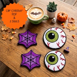 May include: Two purple star-shaped coasters with black spiderweb patterns and two round coasters featuring a green eyeball design with red veins. An orange starburst graphic contains the text car coaster PDF & 2 Sizes in black lettering.