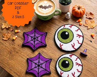 May include: Two purple star-shaped coasters with black spiderweb patterns and two round coasters featuring a green eyeball design with red veins. An orange starburst graphic contains the text car coaster PDF & 2 Sizes in black lettering.