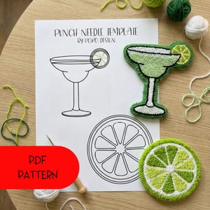 May include: A punch needle template by Poko Design featuring a margarita glass and lime slice design. The image includes a finished green and white margarita glass, a lime slice, and a PDF pattern. Yarn and a punch needle are also visible.