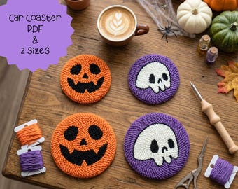 May include: Four round punch needle coasters featuring two orange jack-o'-lantern faces and two purple skulls with white details. The set includes orange, purple, and white yarn spools, a wooden punch needle tool, and metal scissors on a wooden surface.