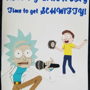 May include: A white birthday greeting card featuring layered paper cutouts of Rick and Morty. Rick is kneeling with a microphone, while Morty stands holding a tambourine. The text at the top reads: HAPPY BIRTHDAY Time to get SCHWIFTY! in blue.