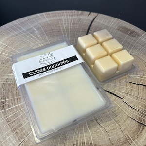 May include: A pack of white scented wax cubes for a candle warmer. The packaging has a black label with the text "Cubes parfumés pour brûle-parfum" and the logo "Bain & Bulles Artisanale".