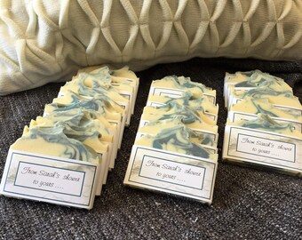 May include: A stack of 15 bars of handmade soap with a swirl of green and white. Each bar has a label that reads "From Sarah's shower to yous..."