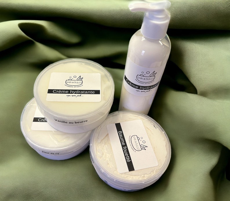 May include: Four white jars of body cream with black labels. The labels have the text "DAN & BULLES" and the names of the creams: "Cr&egrave;me hydratante", "Vanille au beurre", and "Baume fouett&eacute;".