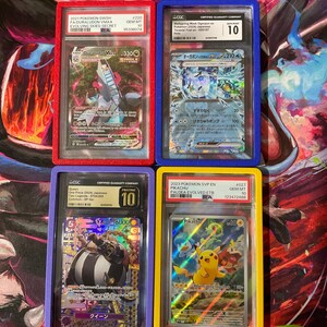 May include: Four graded Pokémon trading cards in protective cases. The cards feature various characters and designs, including Duraludon VMAX, Pikachu, and others. Each case is a different colour, red, blue, purple, and yellow.