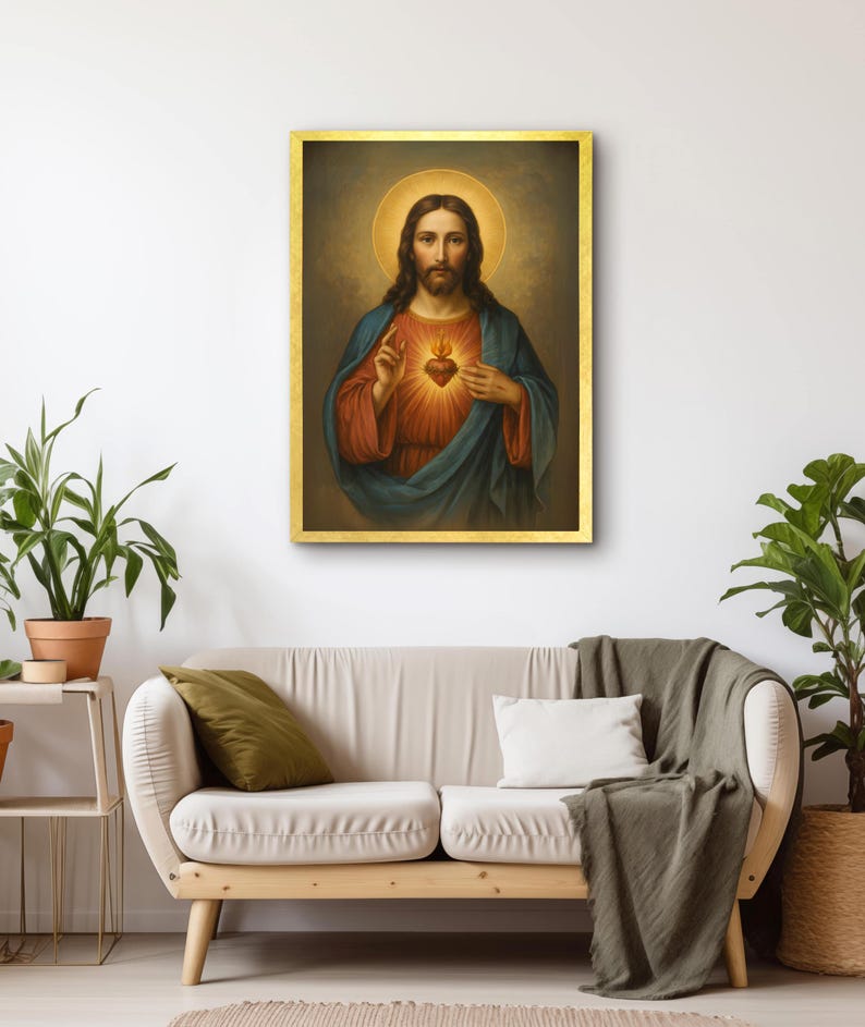 May include: A framed religious portrait of Jesus Christ, depicted with a halo and a glowing heart. The artwork features a gold frame and is displayed on a white wall above a beige sofa. The painting's colors include red, blue, and gold.