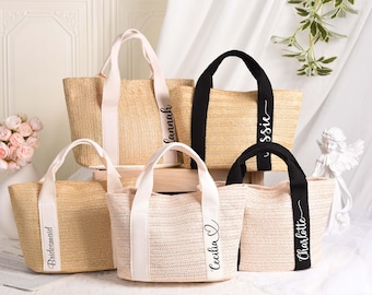 May include: A collection of woven tote bags in various sizes. Some bags have white or black handles and straps with names like "Hannah", "Cecilia", and "Charlotte" printed on them. The bags are beige and light pink, with a natural, summery aesthetic.