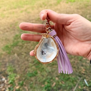 May include: A set of three ceramic mugs with a speckled, matte finish. The mugs are in shades of cream, light gray, and dark gray. Each mug has a simple, minimalist design, perfect for coffee or tea.