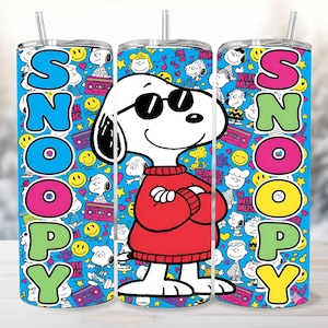 May include: Three stainless steel tumblers featuring Snoopy in sunglasses and a red sweater. The word "SNOOPY" is spelled out in colorful letters. The background is a blue pattern with Snoopy and Peanuts characters.