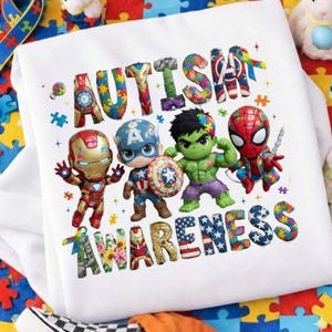 Puede incluir: Sudadera blanca con las palabras "CONCIENCIACIÓN SOBRE EL AUTISMO" con diseños coloridos de rompecabezas y flores. El diseño incluye ilustraciones de Iron Man, Capitán América, Hulk y Spider-Man.