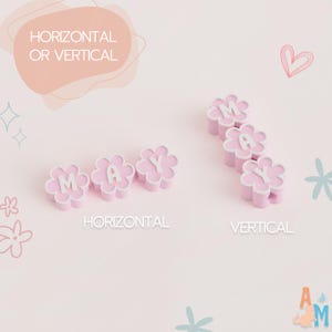 Puede incluir: Cuentas de color rosa claro en forma de flor con letras blancas que deletrean MAY, dispuestas en orientaciones horizontal y vertical. El texto HORIZONTAL OR VERTICAL es visible en la parte superior, con las etiquetas HORIZONTAL y VERTICAL debajo.