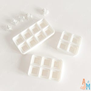 May include: A collection of white plastic mechanical keyboard switch testers and individual clear switch components. The set includes one rectangular tray with eight slots, one square tray with four slots, and one rectangular tray with six slots.