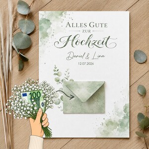 May include: A white wedding card featuring green watercolor accents, eucalyptus leaves, and the text Alles Gute zur Hochzeit, Daniel & Lina, 12.07.2026. A small green envelope is attached to the center, and a hand holds a bouquet of baby's breath.