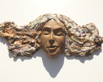 Ceramic wall hanging face sculpture, textured glazes, wild hair portrait art, figure mask painting