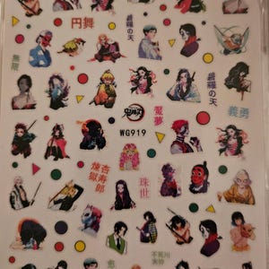May include: Sheet of nail art stickers featuring various anime characters in vibrant colors. The sheet includes images of characters with swords, masks, and other accessories. Text in Japanese characters is also present. The stickers are arranged on a clear background.