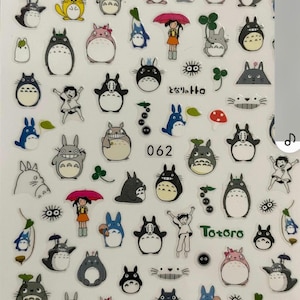 May include: A sheet of stickers featuring various characters from the animated film My Neighbor Totoro. The stickers are printed on clear plastic and feature a variety of colors, including blue, green, yellow, red, and black. The stickers feature the characters Totoro, the Catbus, and other creatures from the film. The stickers are perfect for adding a touch of whimsy to your planner, laptop, or phone.