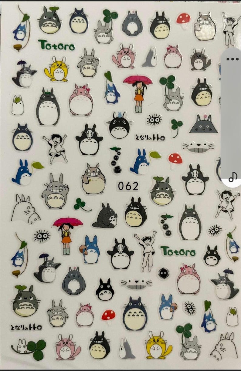 May include: A sheet of stickers featuring various characters from the animated film My Neighbor Totoro. The stickers are printed on clear plastic and feature a variety of colors, including blue, green, yellow, red, and black. The stickers feature the characters Totoro, the Catbus, and other creatures from the film. The stickers are perfect for adding a touch of whimsy to your planner, laptop, or phone.