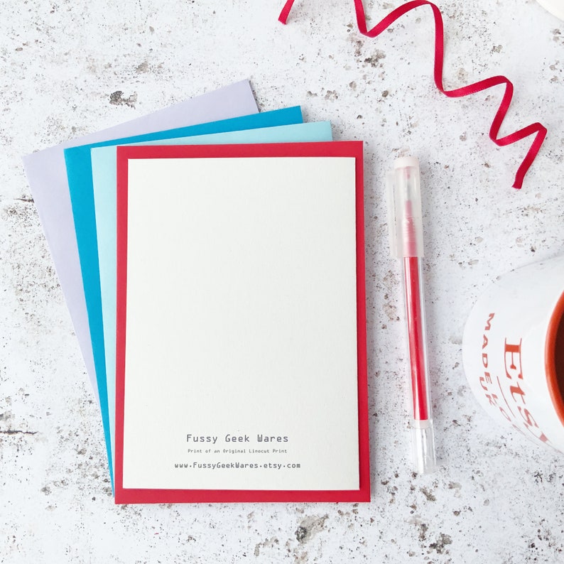 May include: A red card with a white border and a white background. The card has the text "Fussy Geek Wares" printed in black at the bottom. The text "Print of an Original Lineart Print" is printed in black below the title. The text "www.FussyGeekWares.etsy.com" is printed in black below the previous text.